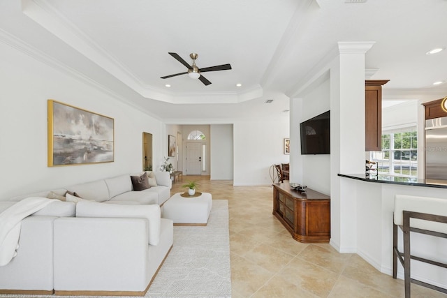 living area featuring crown molding, recessed lighting, a ceiling fan, and a raised ceiling