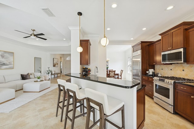 kitchen with open floor plan, visible vents, dark countertops, and appliances with stainless steel finishes
