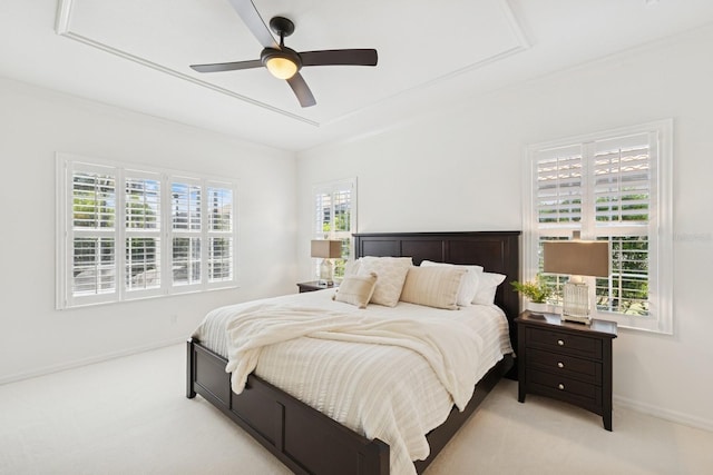 carpeted bedroom featuring baseboards and ceiling fan