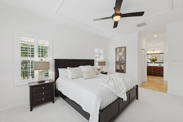 bedroom with ornamental molding, baseboards, connected bathroom, visible vents, and light carpet