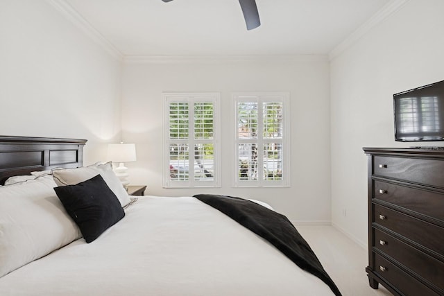 carpeted bedroom with baseboards, crown molding, and ceiling fan
