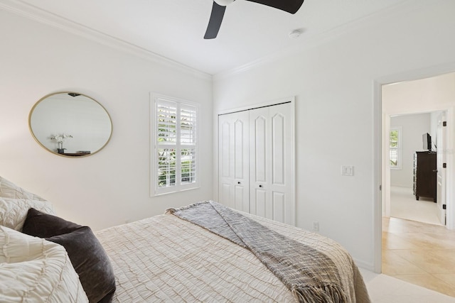 bedroom with a closet, ceiling fan, ornamental molding, and light tile patterned floors