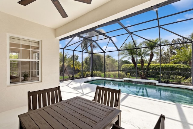pool with a ceiling fan, outdoor dining space, a lanai, and a patio