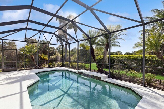 view of pool with glass enclosure