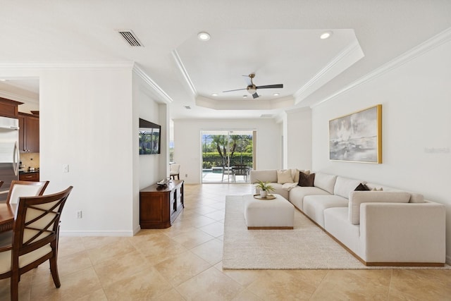 living room with crown molding, ceiling fan, recessed lighting, a raised ceiling, and light tile patterned floors