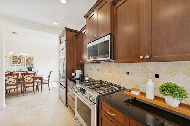 kitchen with tasteful backsplash, crown molding, light tile patterned floors, stainless steel appliances, and a notable chandelier