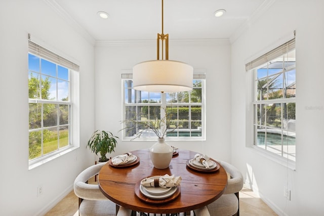 dining space with ornamental molding and a wealth of natural light