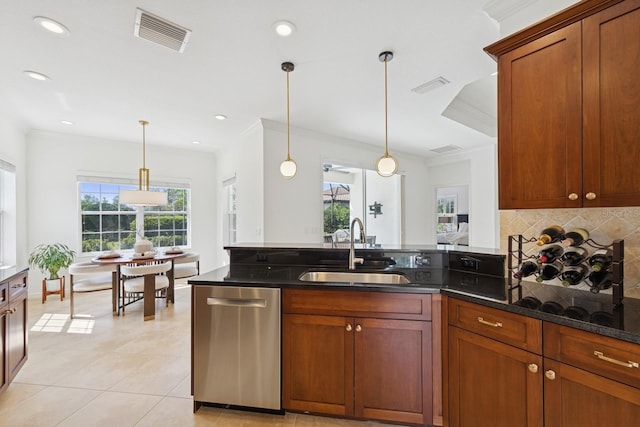 kitchen featuring dark stone counters, a sink, stainless steel dishwasher, and visible vents