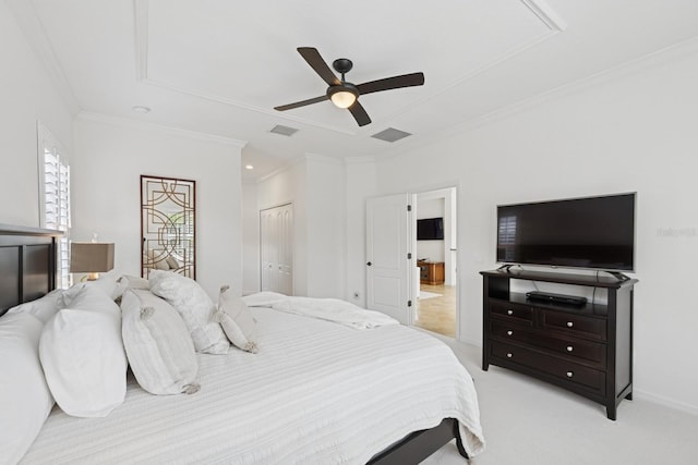 bedroom with crown molding, light colored carpet, ceiling fan, visible vents, and a closet