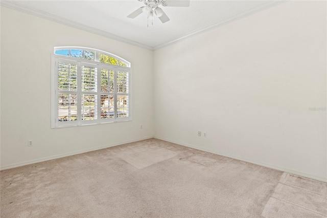 carpeted empty room featuring ornamental molding and ceiling fan