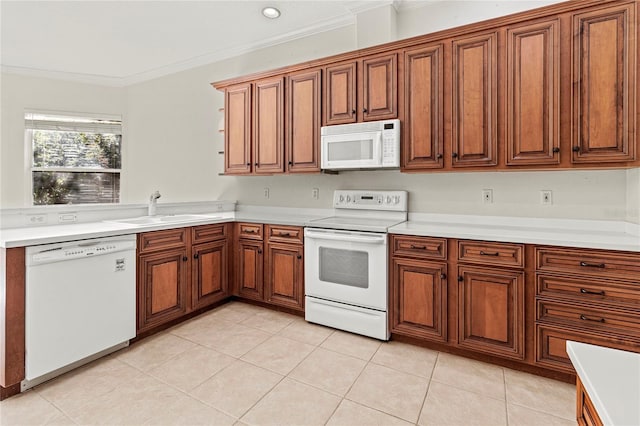 kitchen with crown molding, sink, white appliances, and light tile patterned flooring