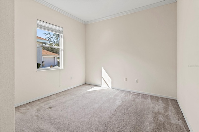 carpeted spare room with crown molding