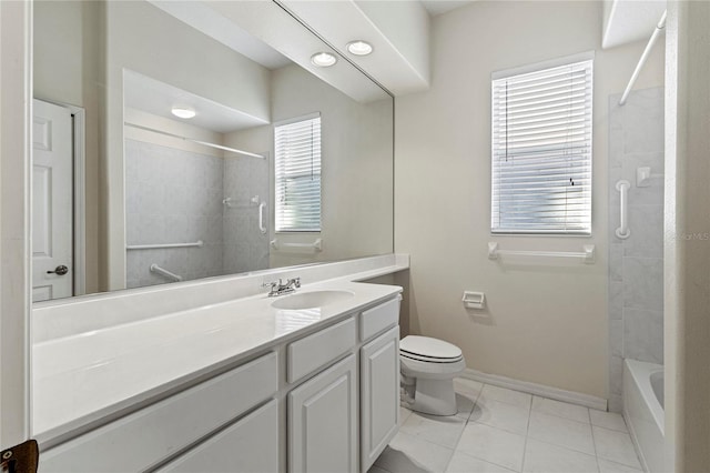 full bathroom featuring vanity, tiled shower / bath, tile patterned floors, and toilet