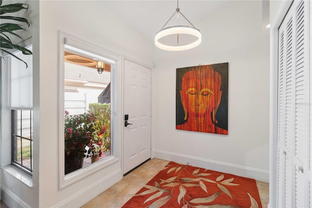 doorway to outside featuring light tile patterned flooring