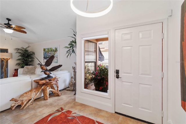 foyer entrance featuring lofted ceiling, light tile patterned floors, and ceiling fan