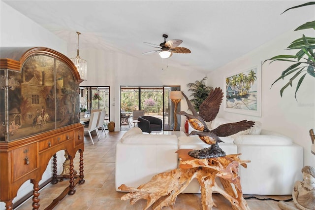 tiled living room featuring lofted ceiling and ceiling fan with notable chandelier