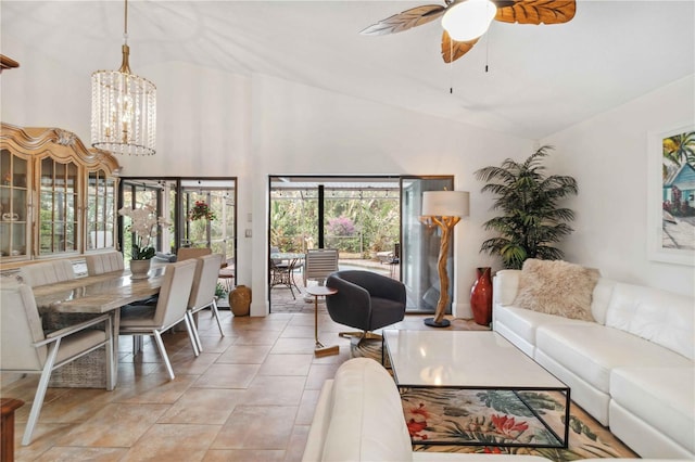 living room featuring high vaulted ceiling, ceiling fan with notable chandelier, and light tile patterned floors