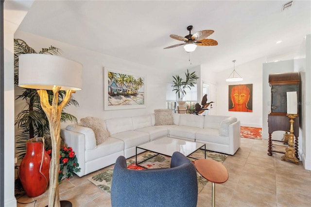 tiled living room featuring ceiling fan and vaulted ceiling