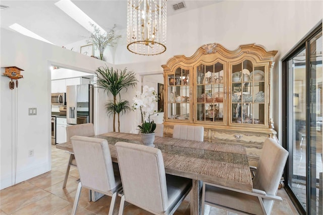 dining room featuring light tile patterned floors, a chandelier, and a high ceiling