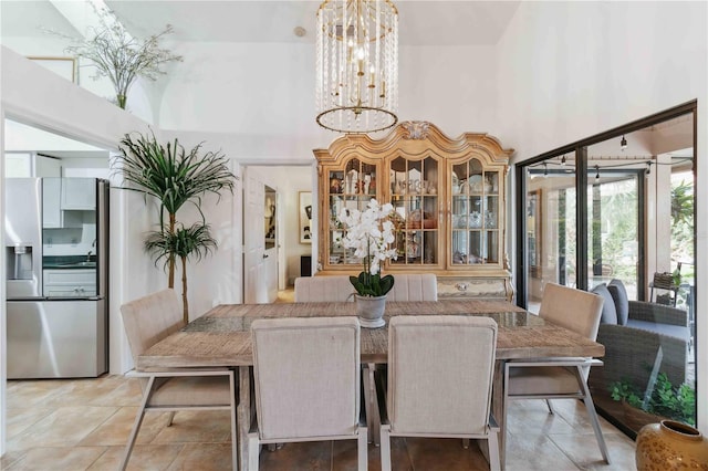 dining space with a notable chandelier and a high ceiling