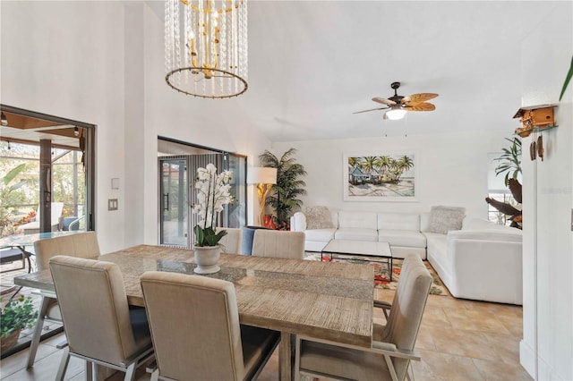 dining room featuring ceiling fan with notable chandelier and a towering ceiling