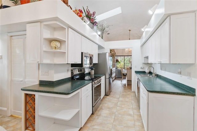 kitchen featuring white cabinetry, sink, light tile patterned floors, and stainless steel appliances