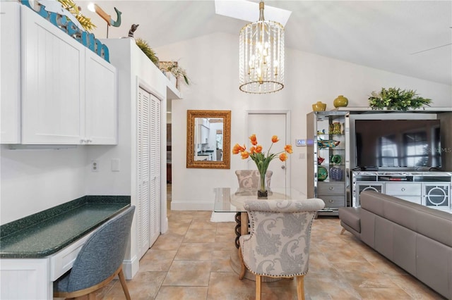 dining room with light tile patterned floors, a notable chandelier, and vaulted ceiling