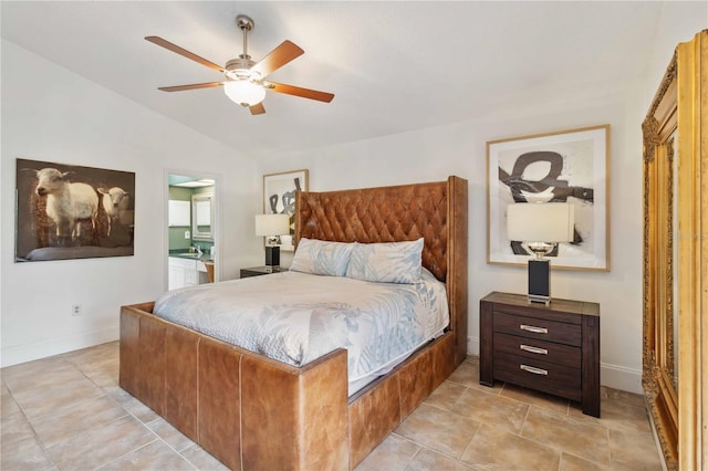 tiled bedroom with lofted ceiling, connected bathroom, and ceiling fan