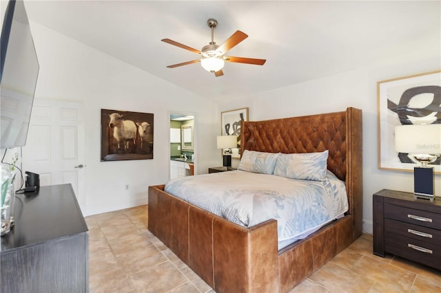 bedroom with ceiling fan, vaulted ceiling, ensuite bath, and light tile patterned floors