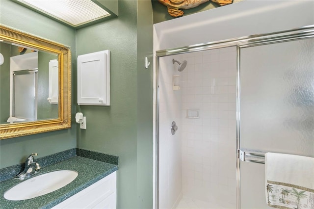 bathroom featuring vanity and an enclosed shower