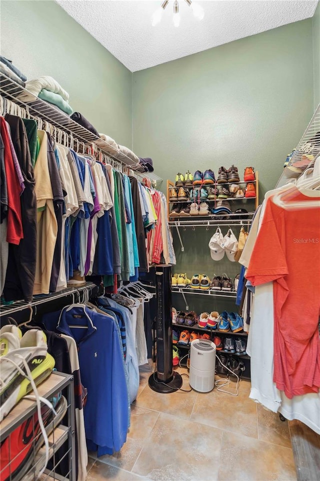 spacious closet with tile patterned floors