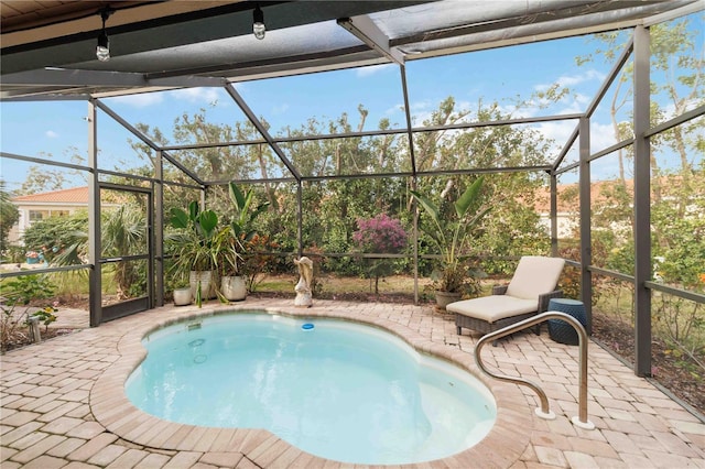 view of pool featuring a patio and glass enclosure