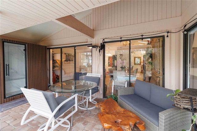 sunroom / solarium featuring vaulted ceiling