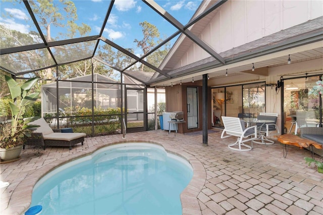 view of pool featuring area for grilling, a lanai, and a patio area