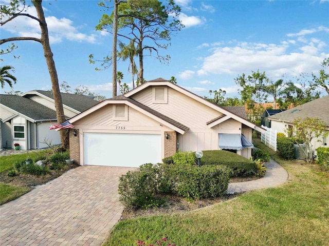 view of front of house with a garage and a front lawn