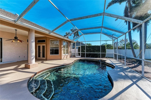 view of swimming pool featuring a lanai, ceiling fan, and a patio area