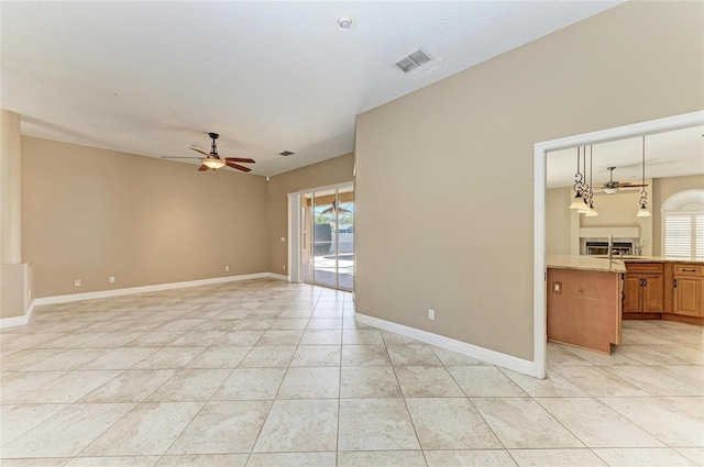 unfurnished room featuring ceiling fan and light tile patterned floors