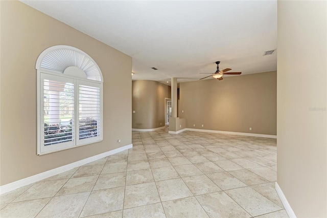 tiled empty room with ceiling fan