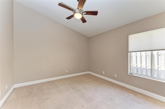 unfurnished room with light carpet, lofted ceiling, and ceiling fan