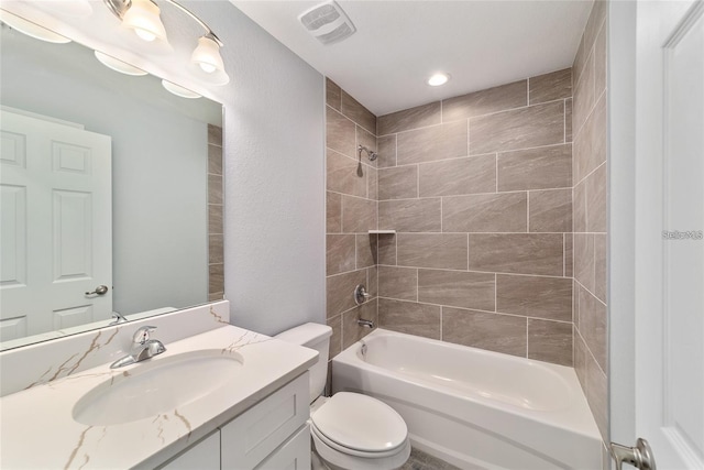 full bathroom featuring vanity, toilet, and tiled shower / bath combo