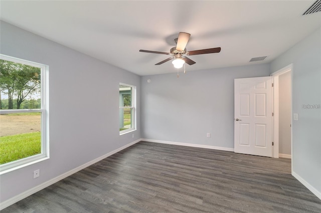 empty room with ceiling fan and dark wood-type flooring