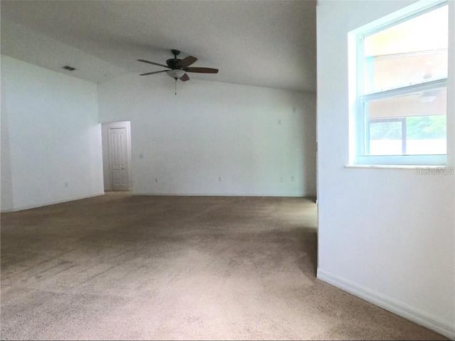 carpeted spare room with ceiling fan