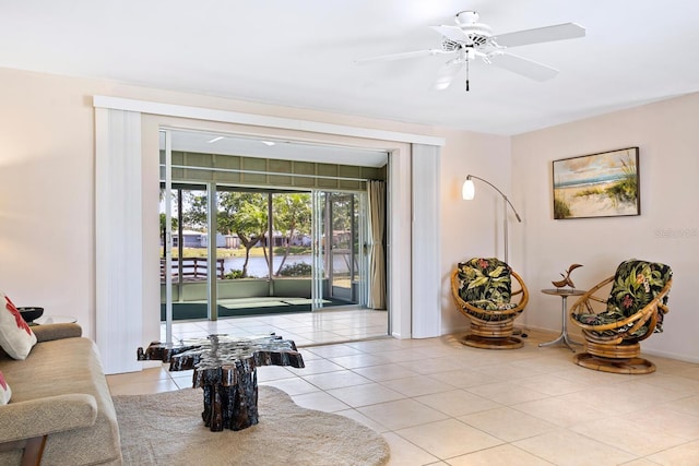 living room with ceiling fan and light tile patterned floors