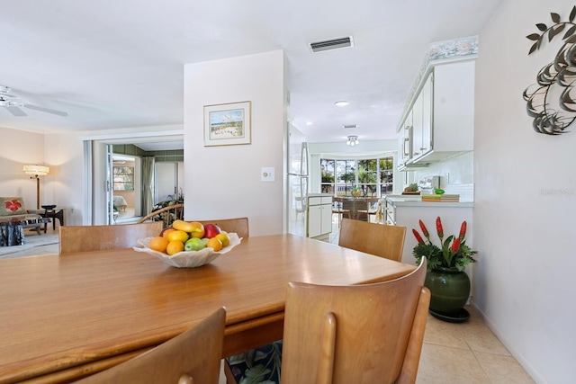 tiled dining area featuring ceiling fan