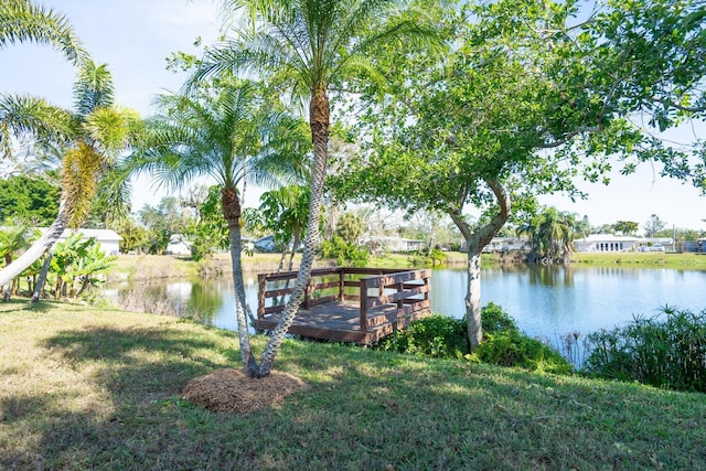 view of dock featuring a water view and a lawn