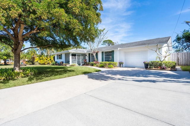 ranch-style home with a garage and a front lawn