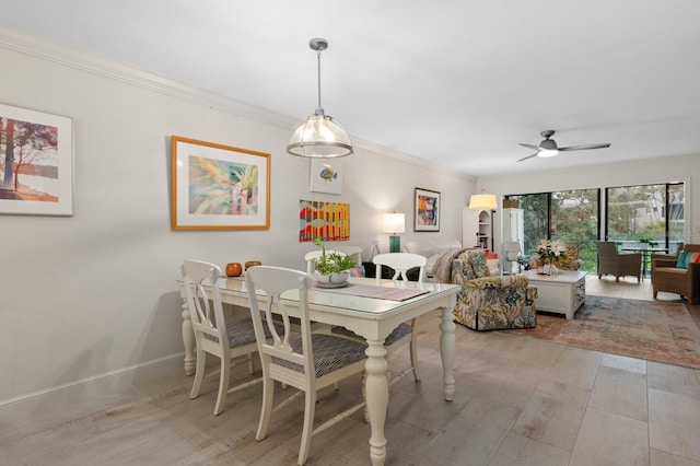 dining space with ornamental molding, ceiling fan, and light hardwood / wood-style flooring