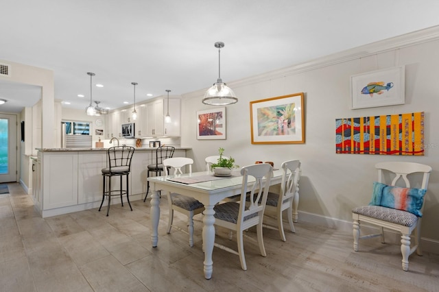 dining area with crown molding