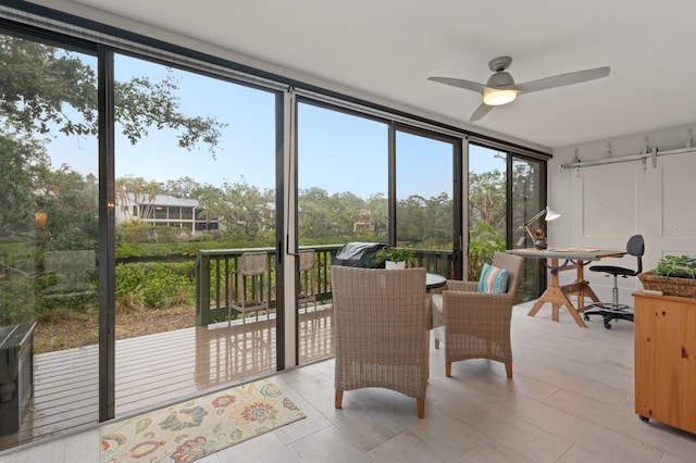 sunroom with a healthy amount of sunlight and ceiling fan