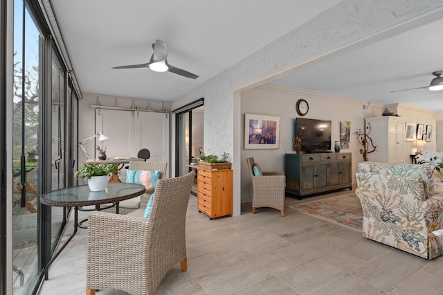 dining area with ceiling fan and ornamental molding